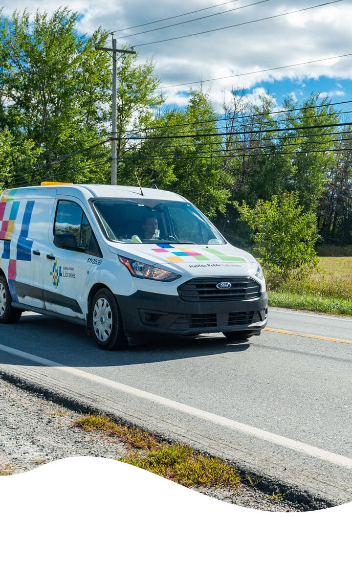 Halifax Public Libraries branded van driving on road.